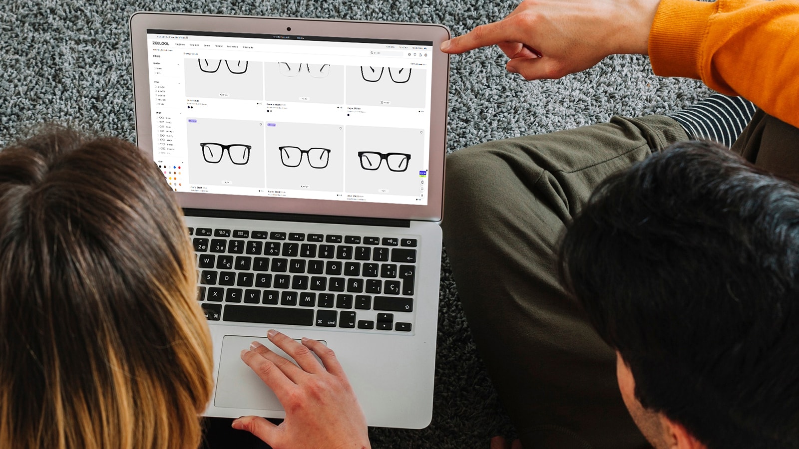 A couple shops for prescription sunglasses on a laptop, following the guide on how to buy glasses online by selecting frame styles.