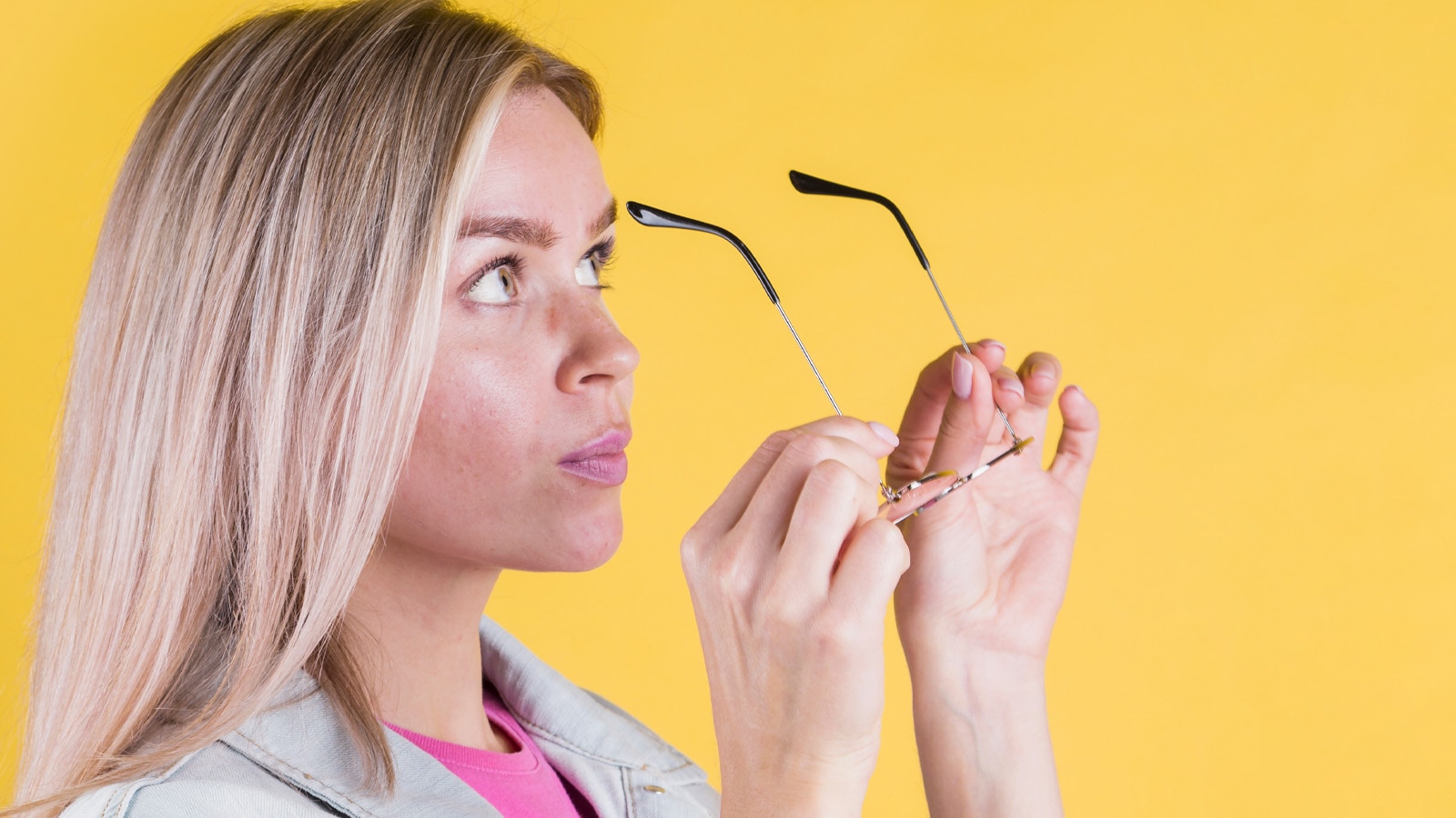 Woman removing glasses to check for nose marks and give skin a break
