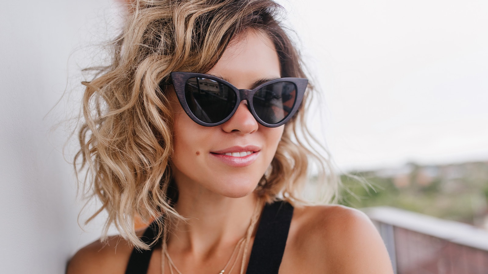 Woman wearing clean polarized sunglasses outdoors for clear vision and style.